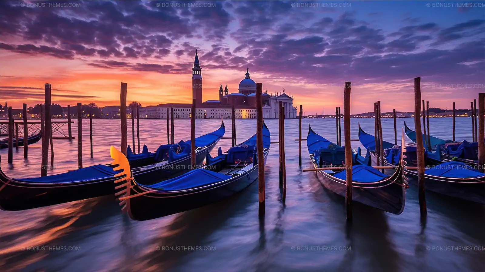 Gondolas at the venice port with sunset